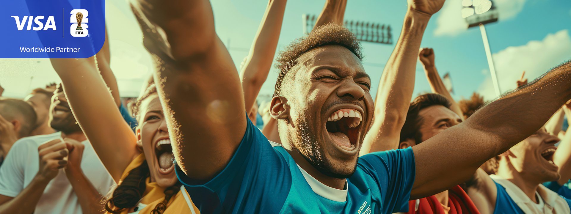Fans in a stadium cheer energetically with arms raised. The central figure, in a blue shirt, displays excitement. Visa and FIFA logos are visible.
