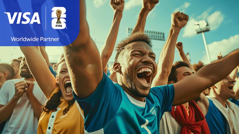 Fans in a stadium cheer energetically with arms raised. The central figure, in a blue shirt, displays excitement. Visa and FIFA logos are visible.