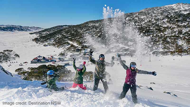 Family enjoying a visit to the Charlotte Pass Ski Resort in the Snowy Mountains.