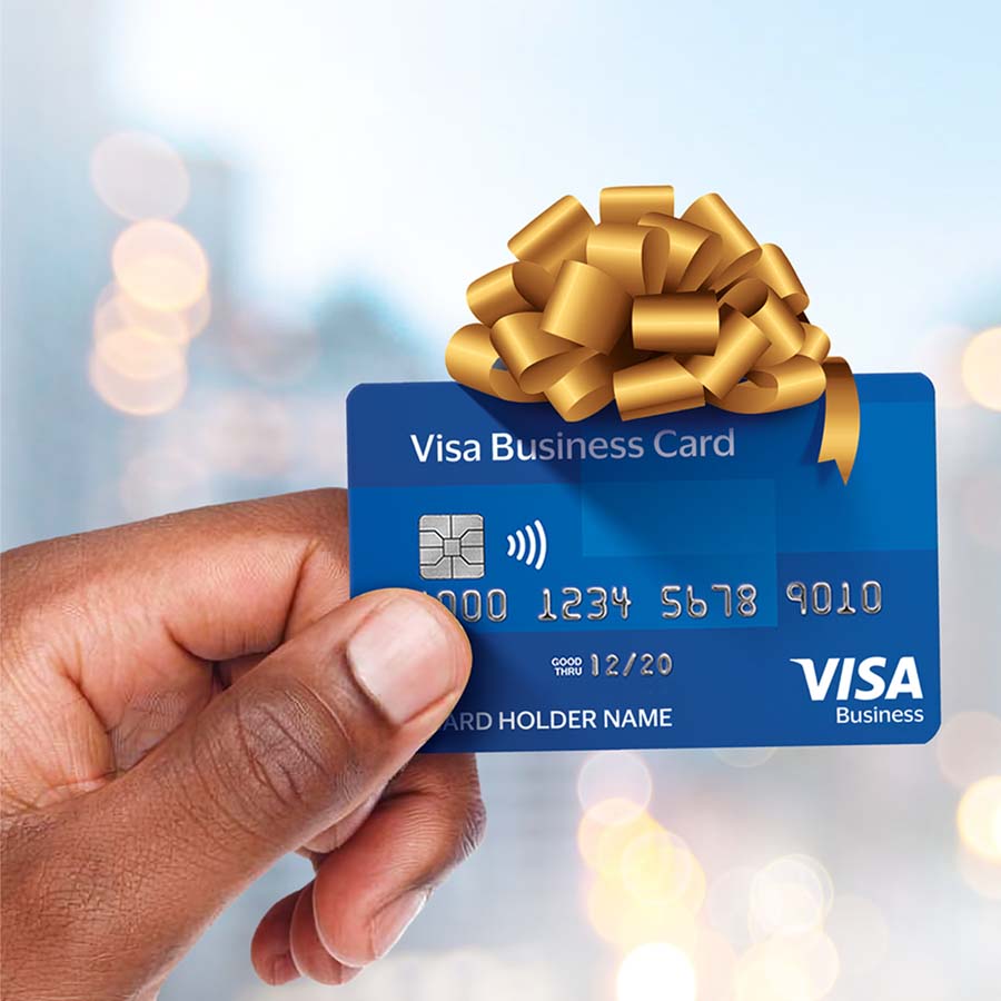 Visa Business Card in the hand with a packaging bow