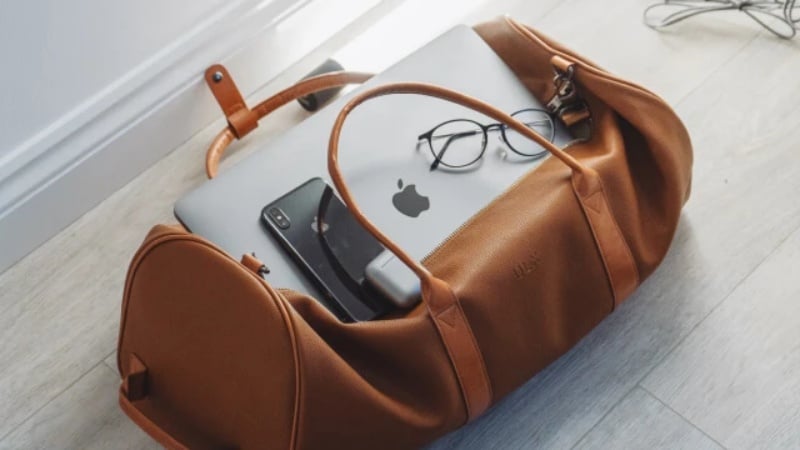 A bag with personal things: laptop, phone, and glasses
